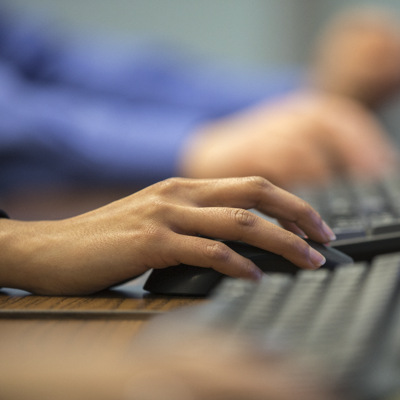 Promotional block. Image of a person’s hand on a computer mouse. Contact us.